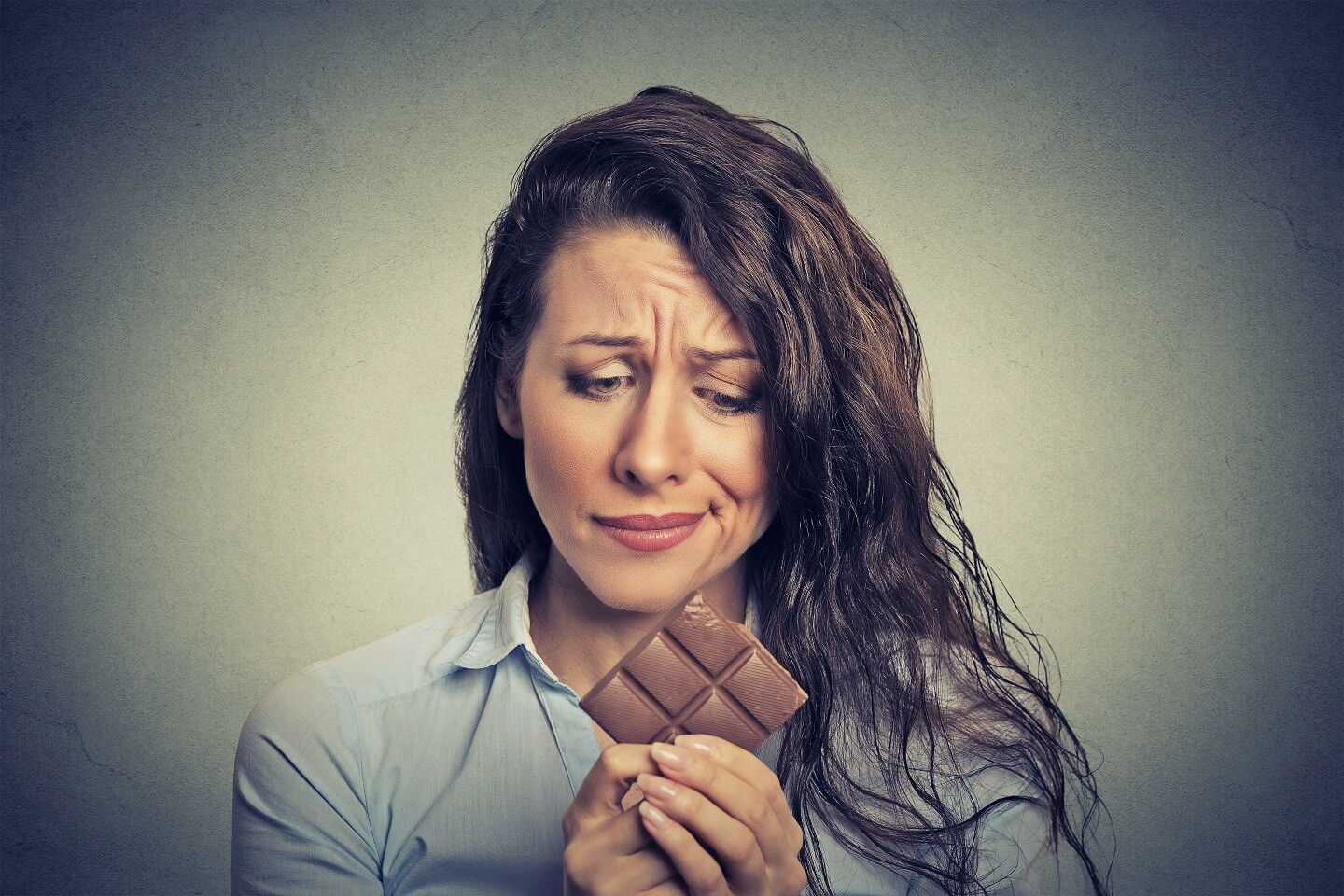 young woman tired of diet restrictions craving sweets chocolate