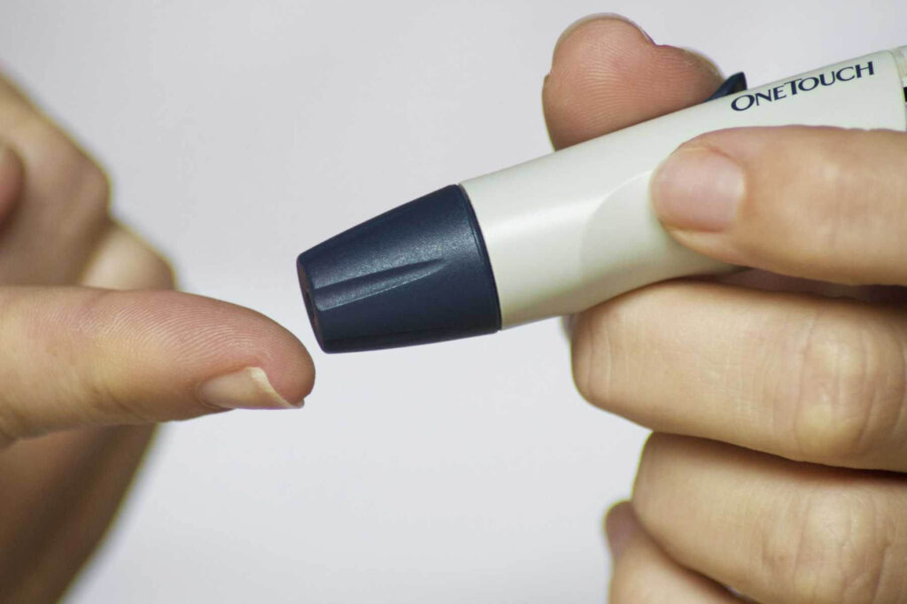 A person testing blood sugar for GLP-1 Medication: Benefits and Side Effects